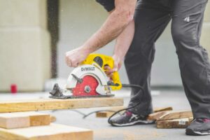 Trader cutting wood for home improvements